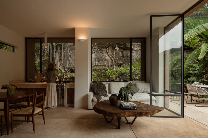 Inside the project, two large windows frame the view of a rocky mountain.